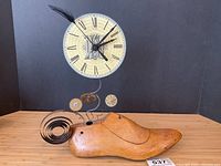 Front view of entire steampunk clock on wooden shoe mold base