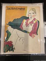 Front cover of songbook in protective sleeve showing illustrated portrait and plant motif