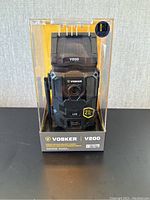 Front of sealed Vosker V200 package showing camera and solar panel