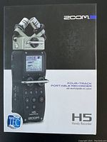 Front of sealed box showing Zoom logo, H5 model name, four-track portable recorder text and TEC award badge