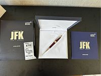 Outer box, open presentation box with pen and booklet