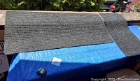 Two gray textured indoor/outdoor floor mats placed on a blue surface, one long and one short, showing condition and size.