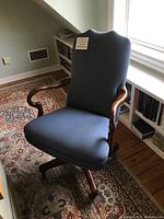 Front-angle view of blue fabric desk chair in room