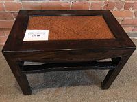 Front view of the rectangular Ming style wooden stool with woven rattan seat insert, showing overall condition and design.
