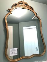 Full front view showing entire curved gold frame and size sticker