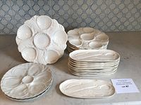 Overview of stacked scallop plates and corn on the cob plates on countertop