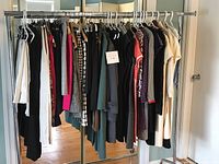 Full metal rack displaying all 25 women’s garments