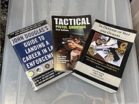 Photo showing all three books together on a transparent surface.