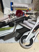 Overview of multiple utensils including a metal whisk, turkey baster, apple slicer, and Farberware branded item.