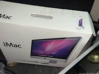 Front of original retail box showing iMac branding and display image
