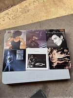 Six 1980s vinyl records including two Pat Benatar albums, Richard Marx album, and three other albums with male artists depicted on the cover.