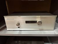 Front view of vintage Dyna FM tuner with volume knob, power switch, and tuning display.