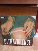 Front cover of ULTRAVIOLENCE album showing close-up hands tearing blue jeans with red nails.