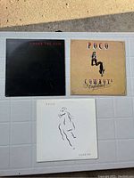 Three Poco vinyl records arranged in rows showing cover art of Under the Gun, Cowboys & Englishmen, and Legend albums.