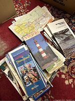 Top view of stack of vintage roadmaps and brochures featuring Virginia and camping guides