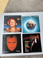 Photo showing all four vinyl LP records with front cover art visible.