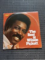 Front cover of The Best of Wilson Pickett vinyl record album featuring a close-up image of Wilson Pickett and title text on an orange background.