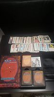Wide shot showing hundreds of Magic: The Gathering cards spread out with Deckmaster boxed set below.