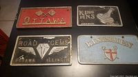 Four vintage car club plaques showing overall condition and relative size