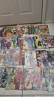 Top view of the lot showing many comic books with colorful superhero covers in varying conditions.