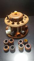 Top and side view of vintage Dun-Rite wooden pipe stand holding several pipes and pipe stems in slots, with wood showing wear.