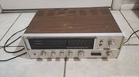 Front view of the Sansui 551 receiver showing control knobs, tuning dial, and power switches.