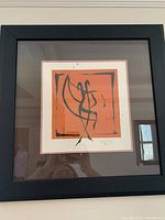 Frontal view of the signed abstract art print in a black beveled frame