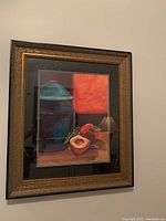 Front view of framed still life painting including peaches and jar with double matting and ornate frame