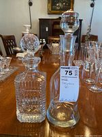 Two decanters on dining table with crystal and cut glass styles visible