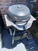 Full view of the Char-Broil Patio Bistro electric grill with lid closed, showing handle and structure.