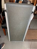 Top down view of the foldable pet ramp showing the grey textured non-slip surface worn with scratches.