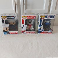 Photo of all three Funko Pop figures in their original boxes showing front display windows and side labels.