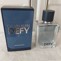 Front view of Calvin Klein Defy EDT bottle and box with visible branding and size 100ml.