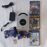 Full lot overview showing GameCube console, controllers, power supply, memory card, and 3 game cases
