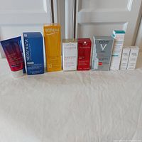 All skincare products in original packaging arranged in a row showing brand and description.