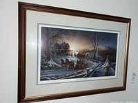 Wide angle of framed Terry Redlin print showing winter rural scene with horse-drawn sled.