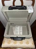 Open Sentry Safe fire safe box showing interior and locking bolts, key inserted in lock.
