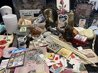Overview of assorted vintage and collectible items from a lady's dresser including mini soaps, perfume, sticker booklet, and small home decorative pieces.