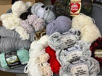 Top view showing a variety of yarn skeins including faux fur, feather, chunky, and other colorful yarns.
