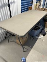 Full view of the table set up, showing top surface and metal bending legs under the table.