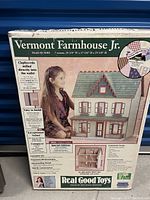Front of sealed original box showing brand, model name, image of assembled dollhouse and promotional callouts