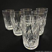 Six tumblers arranged in two rows of three on black background