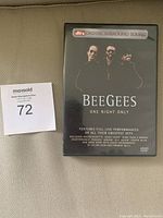 Photo of Bee Gees One Night Only concert DVD case showing front cover with the image of the three band members and text details about the DVD.