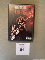 Front cover of the DVD case showing Lenny Kravitz performing live on stage, with title and parental advisory label.