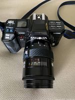 Top view of the Minolta Maxxum 7000 camera body fitted with 80-200mm zoom lens showing camera model and lens details.