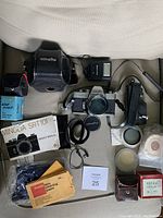 Photo of full lot including Minolta SRT101 camera with lens, flash unit, leather case, manual, cleaning paper, lens cap, cable release, and other accessories.