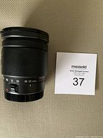 Front side view of Tamron zoom lens showing focal length markings 28 to 200mm and brand name.