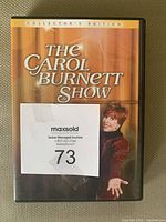 Front cover of The Carol Burnett Show Collector's Edition DVD case showing Carol Burnett in red dress and auction label attached.