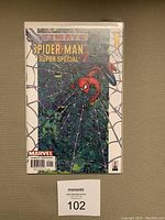 Front cover of Ultimate Spider-Man Super Special #1 comic book in protective sleeve on neutral background.