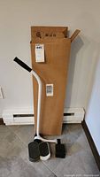 Furniture lifter tool and four furniture sliders with the original cardboard box.